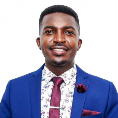 Young black male with bright blue suit jacket, plum tie and pocket square, and white collared shirt with faint floral pattern smiles at camera